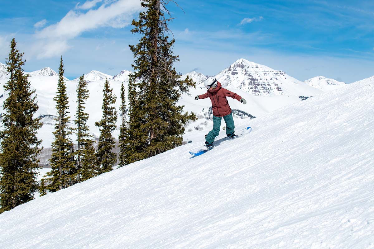 Resort snowboarding with mountains in background